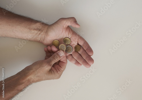 euro coins on man’s hand