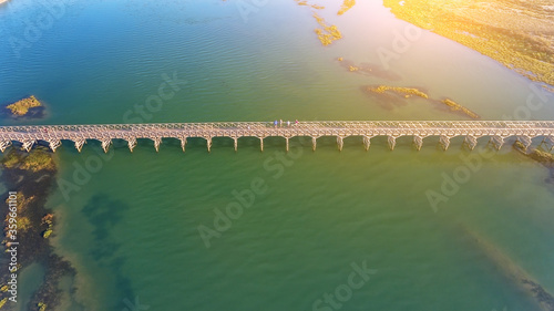 Aerial photo of Quinta de Lago, Almancil, Algarve, Portugal. Bridge over the beach. Dunes. Sunny day.