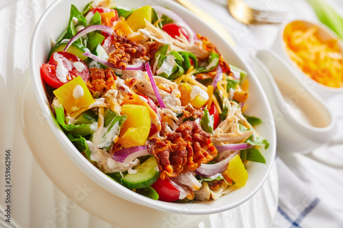 close-up of chicken club salad in bowl