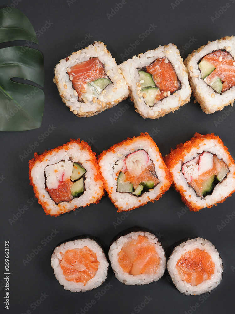 Japanese rolls on black stone background. Japanese rolls on black stone background.