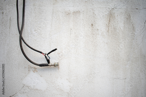 black electrical outlet on a old white wall abstract background 