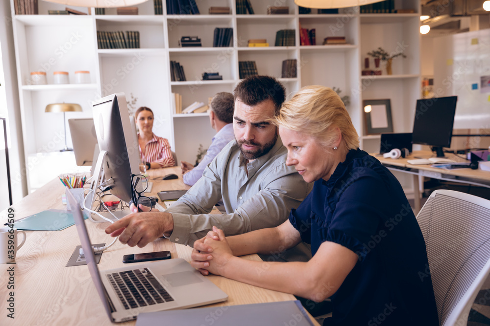 Caucasian businesspeople working together in workspace Caucasian businesspeople working together in workspace