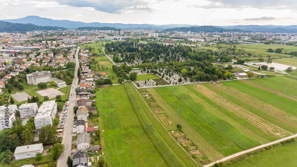 Spectacular cityscape with fields on city outskirts.