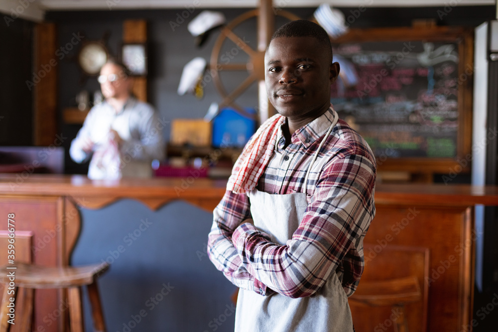 Portrait of an African American barman in a brewery Portrait of an African American barman in a brewery