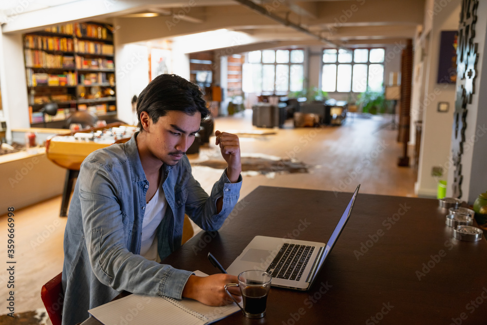 Young man working home on his laptop Young man working home on his laptop