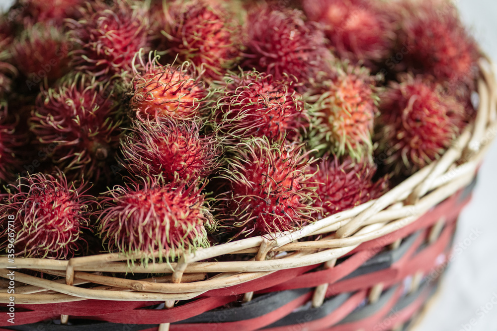 Red rambutans in a red basket 