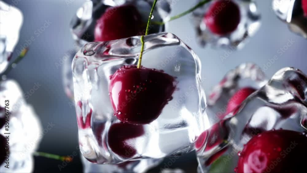 Cherry rotate in ice cubes. Food and broadcast concept. Realistic ice ...