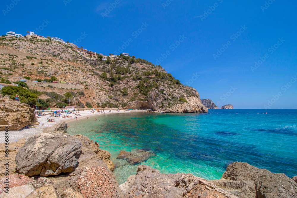 Cala Granadella beach with blue sea water, Spain