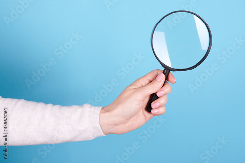 Magnifying glass in hand.