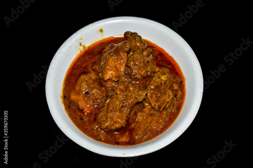 South Indian cuisine Kerala Style Beef curry / roast. Traditional style meat curry on Black background. Indian spicy curry. Selective focus photograph.