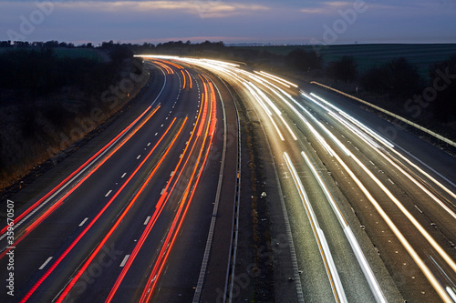 Elevated view of car light trails in the M4 in Swindon, Wiltshire, UK photo