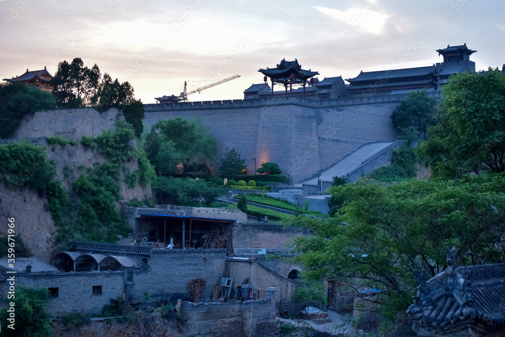 Fototapeta premium Chinese ancient buildings in the setting sun