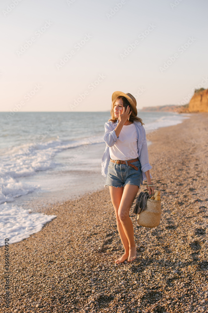 Young beautiful woman posing on summer beach.