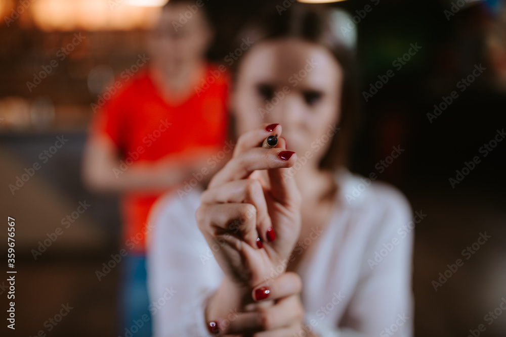 Close up of a hand of a girl throwing an arrow on a dart board Close up of a hand of a girl throwing an arrow on a dart board