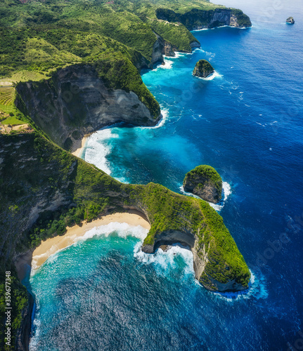 Aerial view at the sea and rocks. Blue water background from top view. Summer seascape from air. Kelingking beach, Nusa Penida, Bali, Indonesia. Travel - image