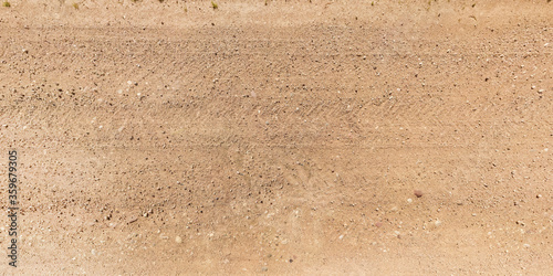 Canvas Print view from above on texture of gravel road with car tire tracks