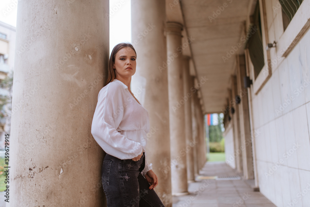 Portrait of a beautiful young caucasian girl in front of a white building Portrait of a beautiful young caucasian girl in front of a white building