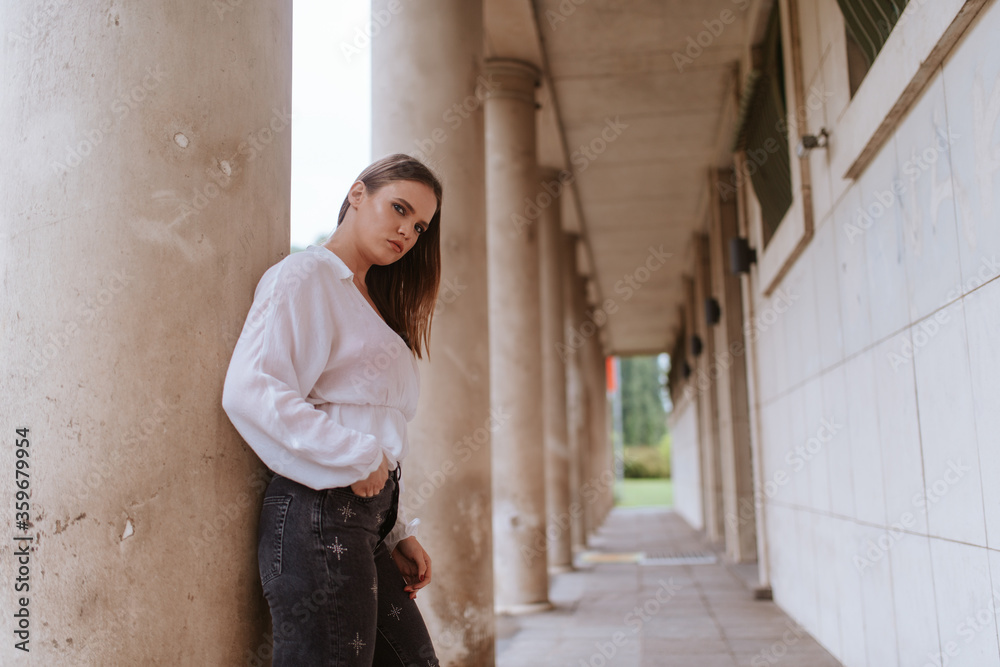 Portrait of a beautiful young caucasian girl in front of a white building Portrait of a beautiful young caucasian girl in front of a white building