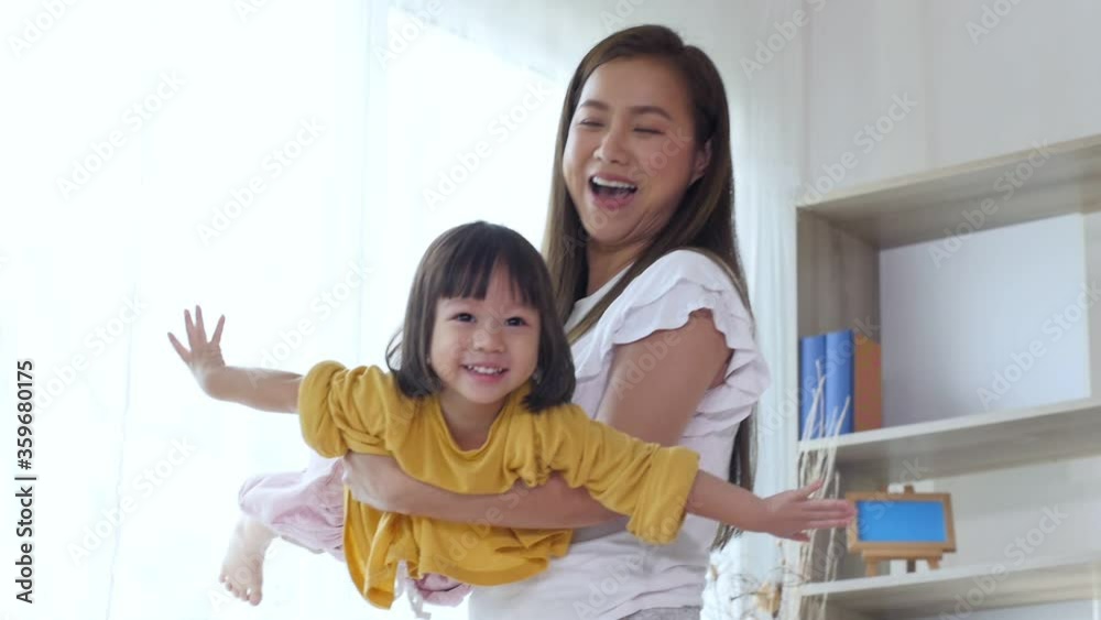 Happy family young mom having fun with lovely daughter ,Asian mother playing with little cute children at home... Happy family young mom having fun with lovely daughter ,Asian mother playing with little cute children at home...