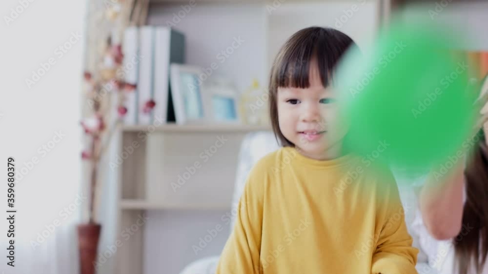 Little Asian girl playing ball with mom. Little Asian girl playing ball with mom.