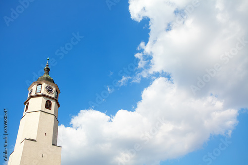 belfry with christian cross and clouds on blue sky 