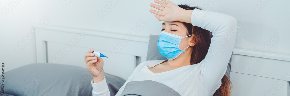 Asian woman flu and cold, feeling sick and using thermometer Checking fever . feeling sick health problems treatment concept Asian woman flu and cold, feeling sick and using thermometer Checking fever . feeling sick health problems treatment concept