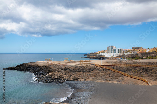 Empty coastal walk and closed beach due to coronavirus lockdown nearby a popular fishing village on the south eastern coast of the island in Los Abrigos, Tenerife, Canary Islands, Spain