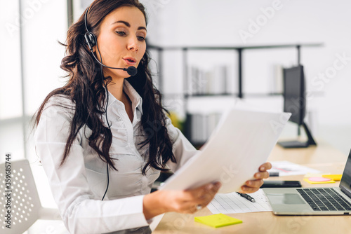Beautiful happy call center smiling businesswoman operator customer support consult phone services agen working with wireless headset microphone and computer at call center office