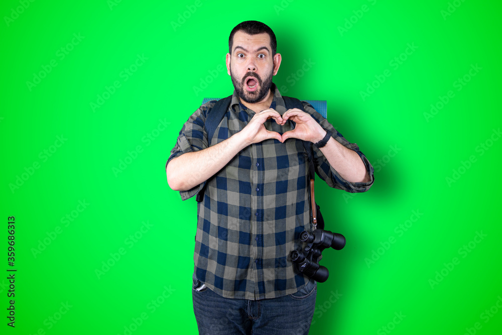 Portrait of happy handsome traveler man making heart with fingers Portrait of happy handsome traveler man making heart with fingers