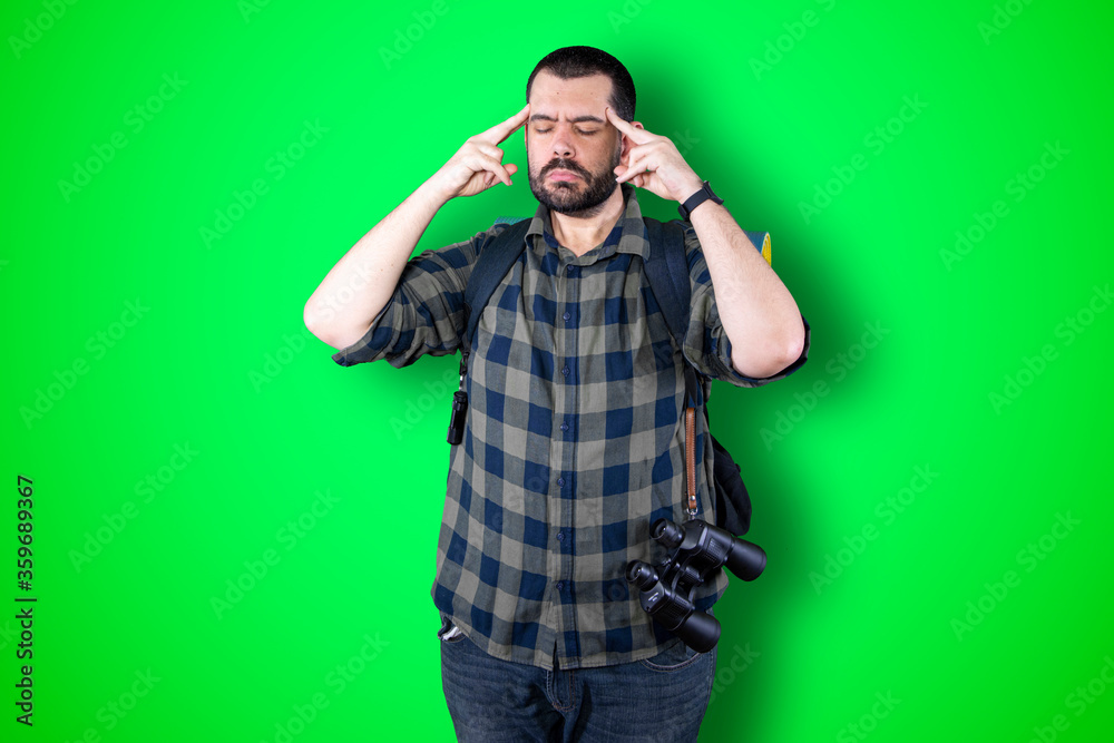 Caucasian handsome traveler man isolated on chroma background thinking an idea while looking up Caucasian handsome traveler man isolated on chroma background thinking an idea while looking up