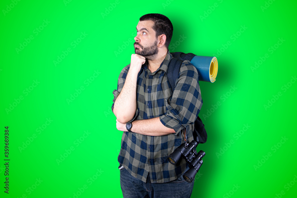 Caucasian handsome traveler man isolated on chroma background thinking an idea while looking up