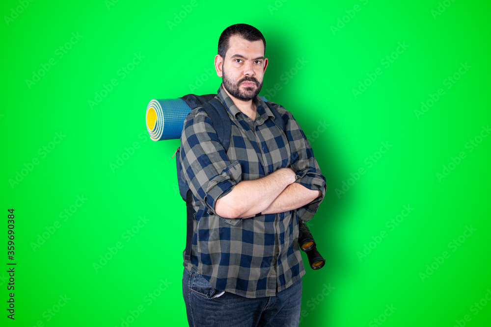 Φωτογραφία Unshaven confident serious young traveler male entrepreneur with attractive appearance dressed casually isolated over chroma studio background