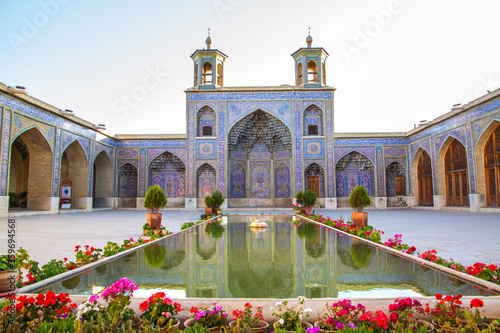 Famous pink mosque decorated with mosaic tiles and religious calligraphic scripts from Persian Islamic Quran, Shiraz, Iran. 