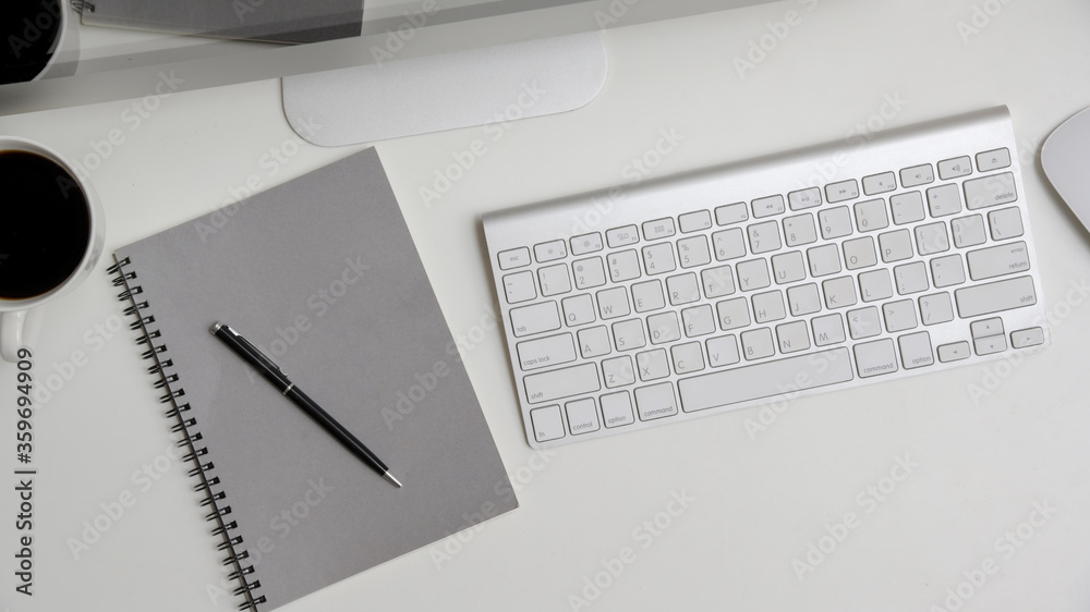 Flat lay, top view office table desk. Workspace with computer, keyboard, notebook and coffee cup on white background. Flat lay, top view office table desk. Workspace with computer, keyboard, notebook and coffee cup on white background.
