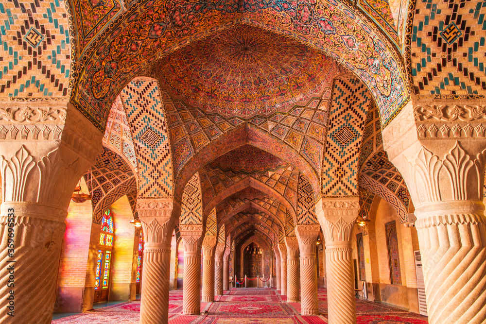 Famous pink mosque decorated with mosaic tiles and religious calligraphic scripts from Persian Islamic Quran, Shiraz, Iran. 