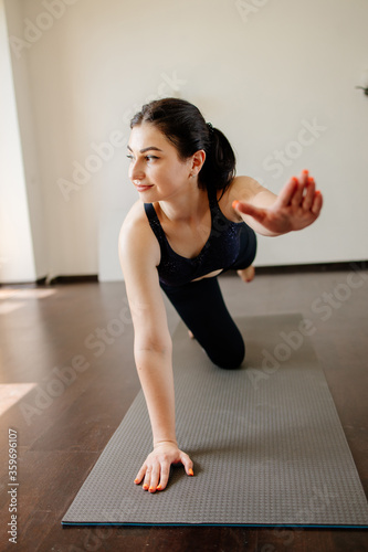 Yoga at home. Fit woman doing workout in her living room. Active lifestyle, physical and mental health © Vadym