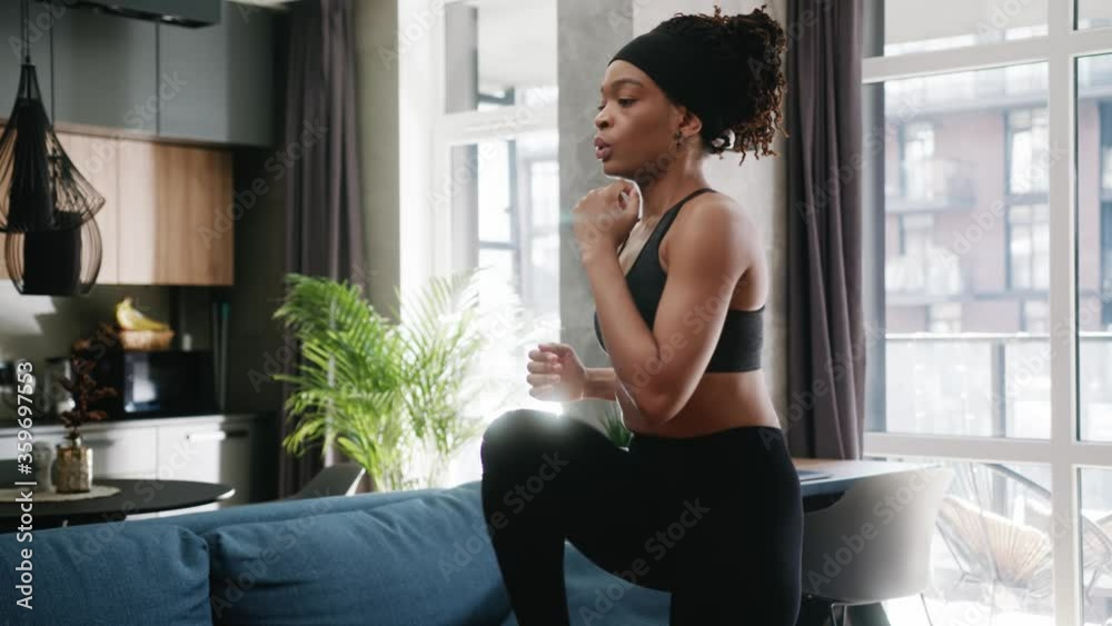Close up african american woman in sportswear doing workout burning fat calories training strength practicing effort domestic fitness females aerobics sport fit at home slow motion Close up african american woman in sportswear doing workout burning fat calories training strength practicing effort domestic fitness females aerobics sport fit at home slow motion