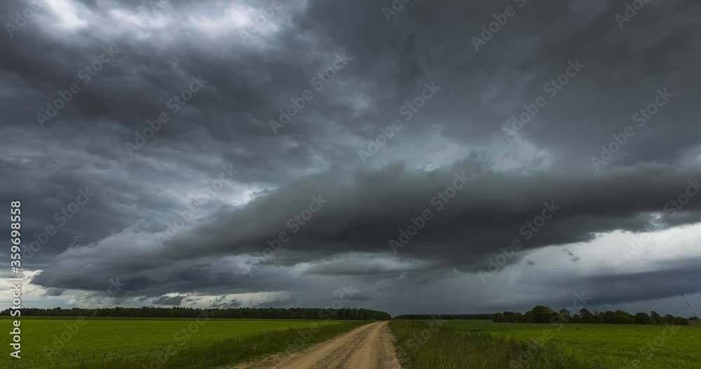 Atmospheric storm clouds fast moving over the ground. Climate change and global warming Atmospheric storm clouds fast moving over the ground. Climate change and global warming
