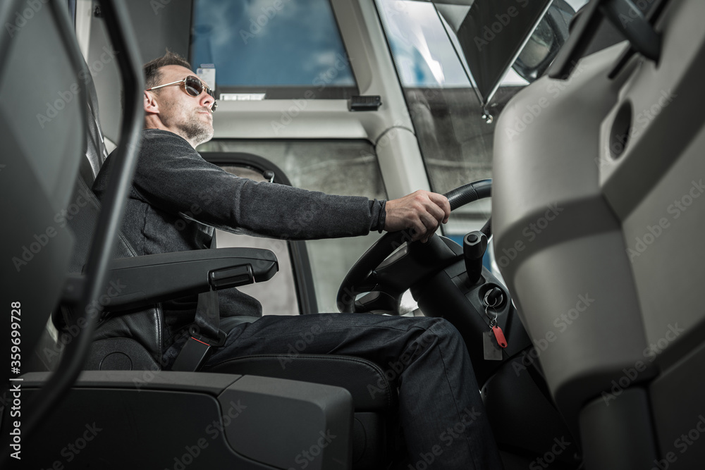 International Coach Bus Driver Preparing For Travelers Pickup International Coach Bus Driver Preparing For Travelers Pickup