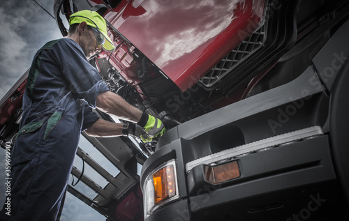Semi Truck Professional Mechanic Servicing Vehicle