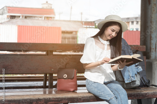Asian traveler woman wait train at railway station.Travel holiday,relaxation concept.