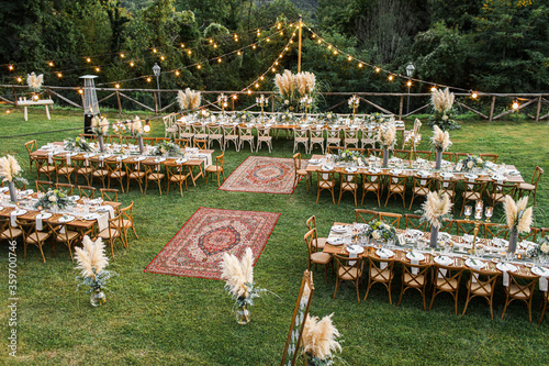 Wedding table set up in boho style with pampas grass and greenery