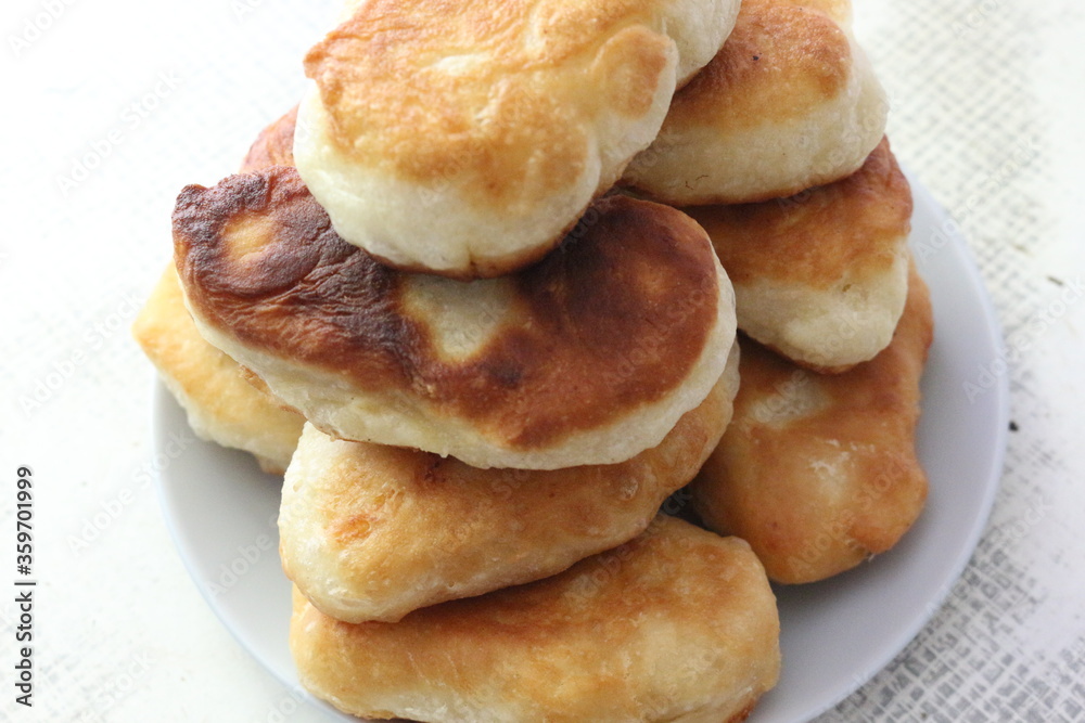 Yeast cakes baked in butter. They are rosy and tasty. Golden crust crunches when eating
Yeast cakes baked in butter. They are rosy and tasty. Golden crust crunches when eating