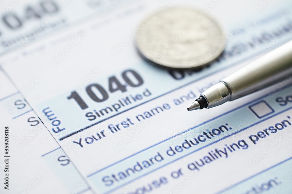 Annual tax reporting. Tax form on the table. Financial statements for signature.