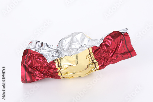 red and gold empty candy wrapper isolated on white background with copy space for your text