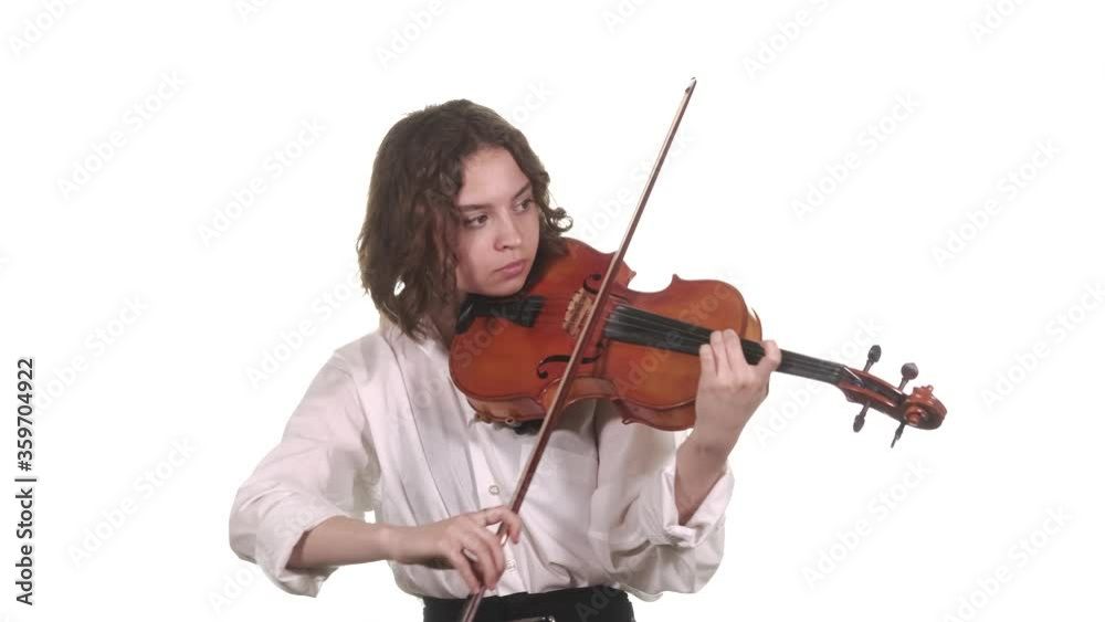 young violinist in a white blouse playing the classical violin. Isolated. Medium long shot young violinist in a white blouse playing the classical violin. Isolated. Medium long shot