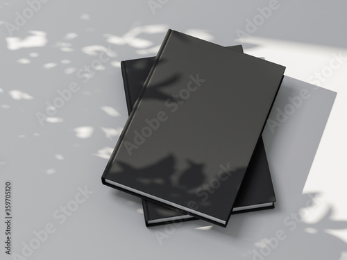 Two Books or Notebooks Mockup with black textured hardcover on white background outdoors