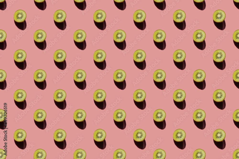 Pieces of ripe juicy kiwi on pastel pink background. Summer bright positive concept. Creative pattern, minimalism, top view, flat lay. Tasty and healthy food. Pieces of ripe juicy kiwi on pastel pink background. Summer bright positive concept. Creative pattern, minimalism, top view, flat lay. Tasty and healthy food.