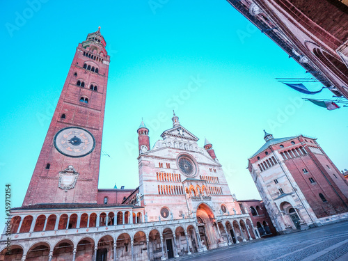 Wide View of Cathedral of Cremona with Torrazzo , talles brick tower of Euorpe, and Baptistery in historical Piazza del Duomo, Cremona, Lombardy, Italy at sunset. photo