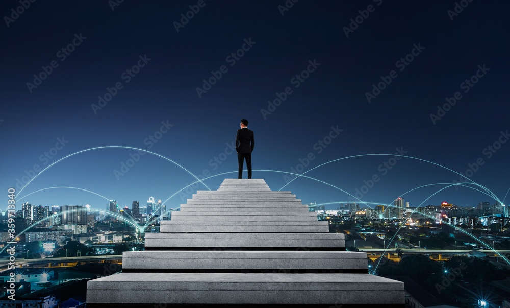 Success person climbed on top of the stairs looking at the cityscape. Success business concept.